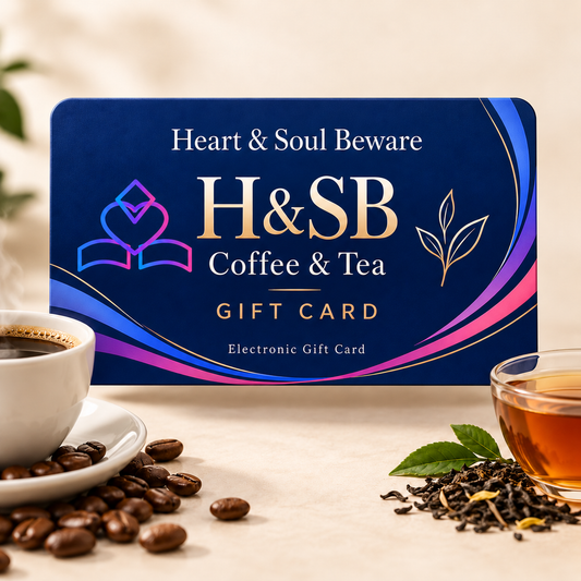 A Heart & Soul Beware Coffee & Tea gift card is displayed on a light beige surface with coffee beans, a cup of black coffee, and a glass of tea. The card features a deep blue background with gold and pink accents and the text 'Heart & Soul Beware H&SB Coffee & Tea Gift Card'.